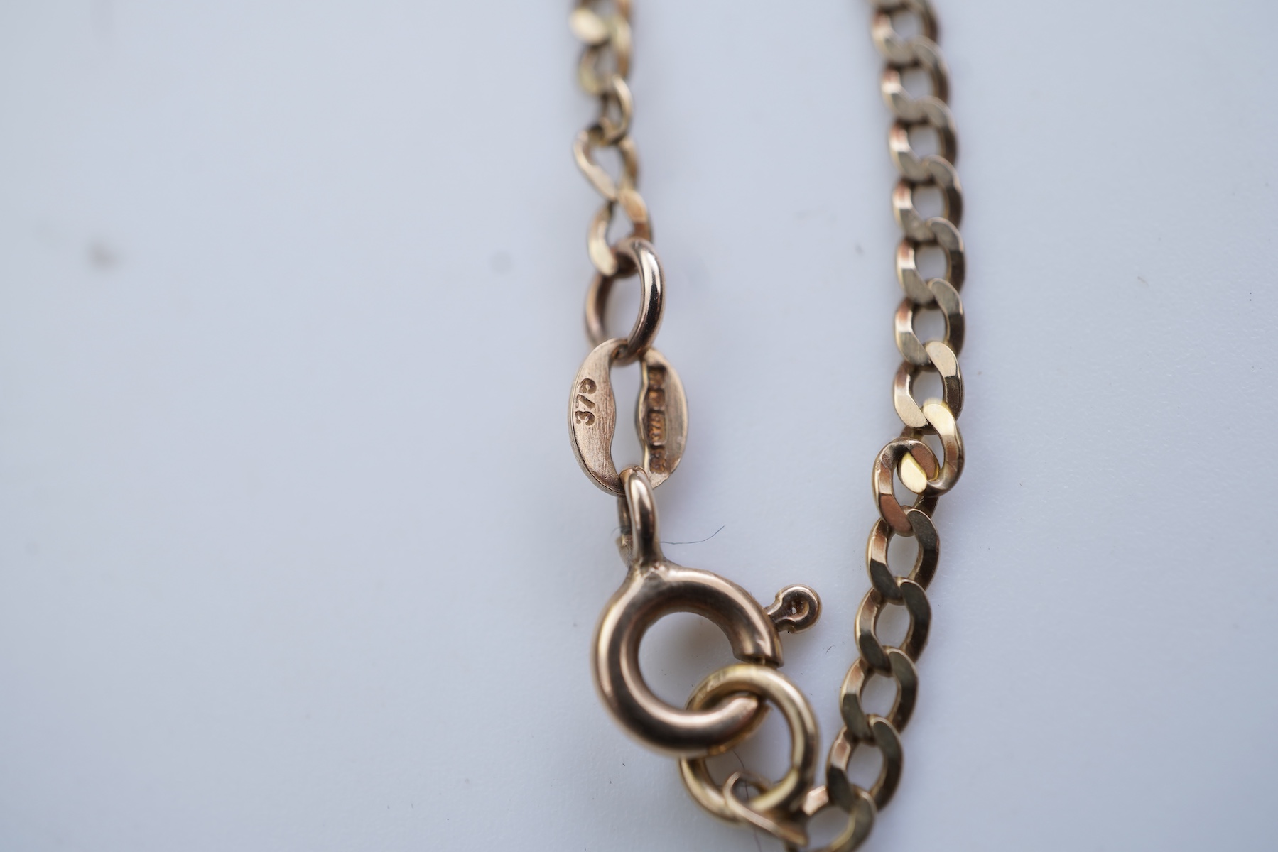 Two gold bracelets and a gold necklace
